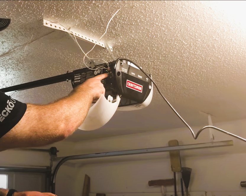 Professional installing a high-quality garage door opener in a residential garage in Bradenton, FL, showcasing expert garage door opener installation services.