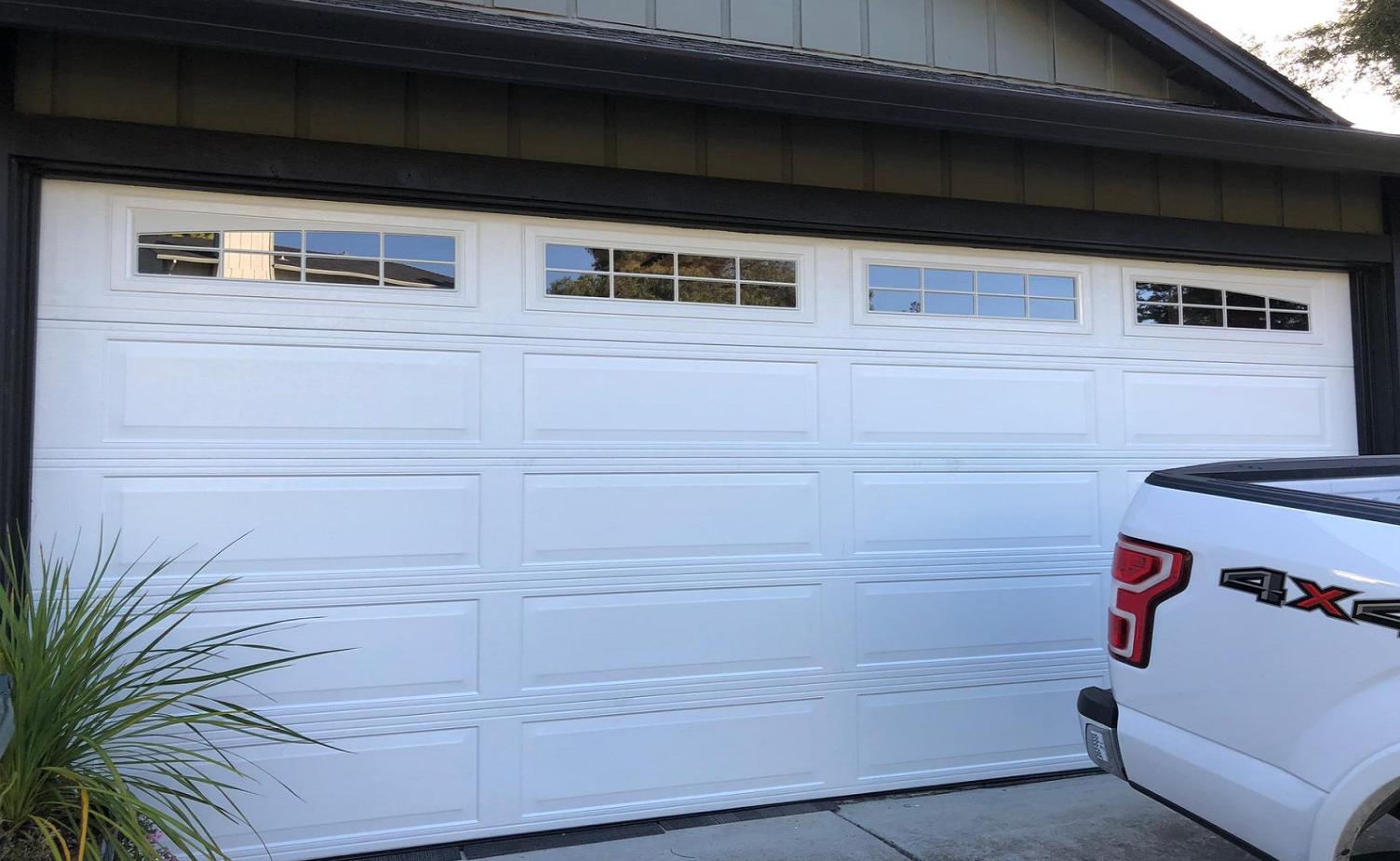 Technician providing same-day garage door repair service in Bradenton, FL, fixing a residential garage door.