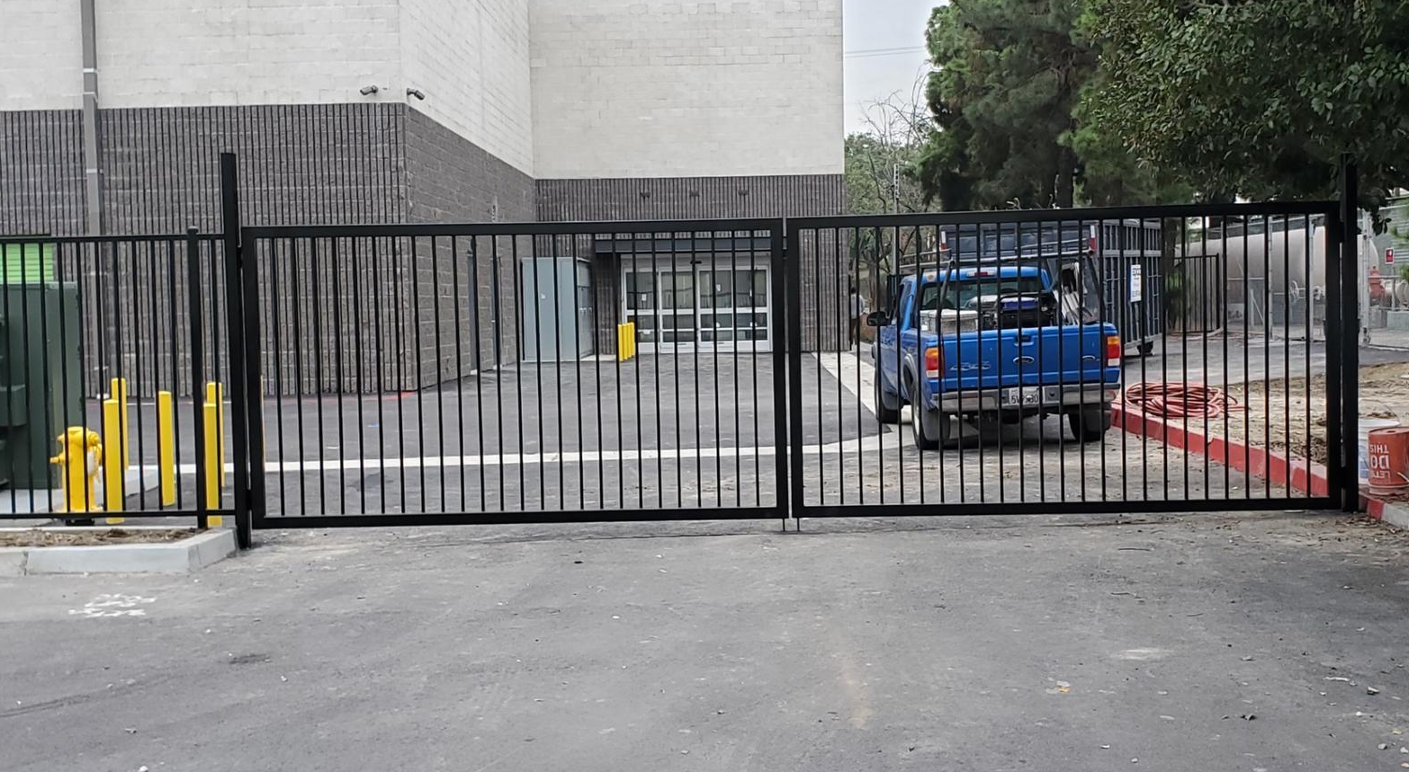 Team of professionals performing commercial gate repair for Bradenton FL Garage Door Services at a business establishment.