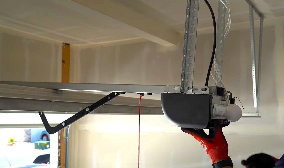 Professional technician repairing a garage door opener with branded tools in Bradenton, FL, showcasing expert garage door opener repair services.