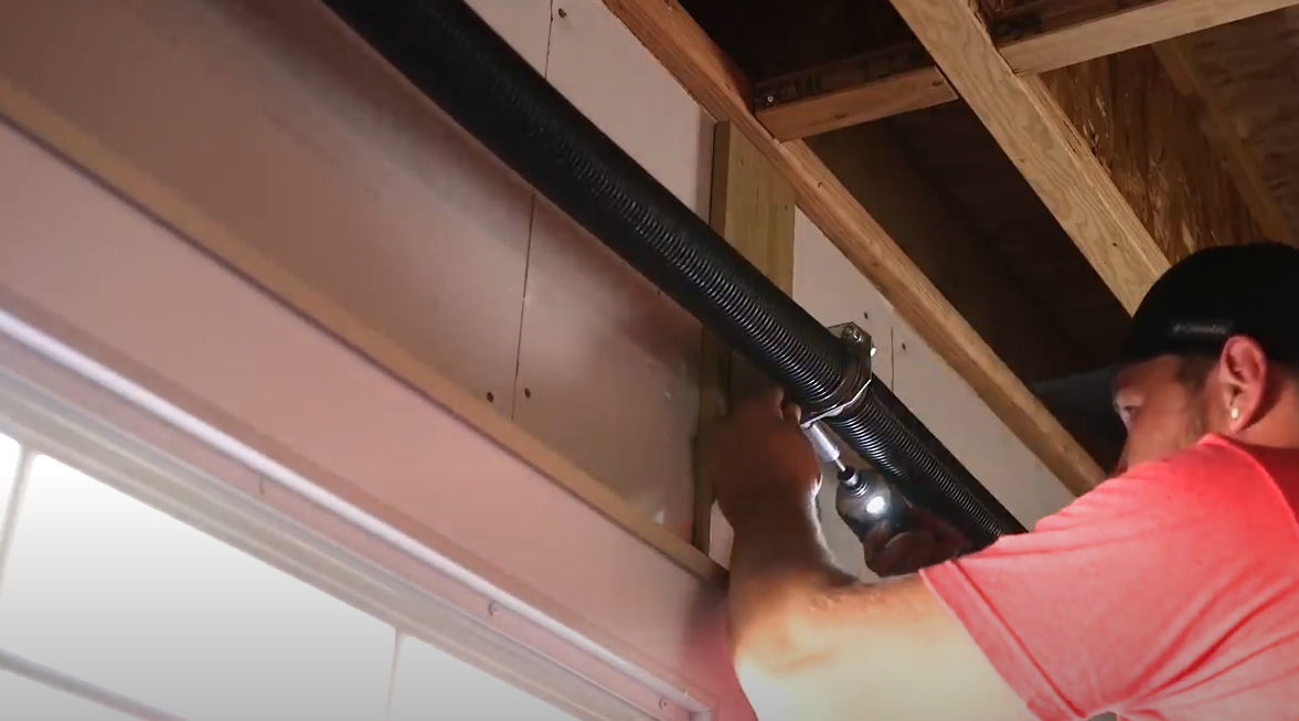 Close-up image of a technician expertly repairing a garage door spring, showcasing Bradenton FL Garage Door Services