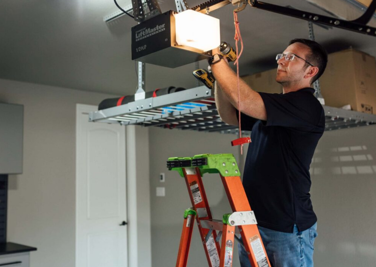 a technician repairing a garage door opener in Bradenton, FL, illustrating the professional services offered by Bradenton FL Garage Door Services for efficient and reliable garage door opener repair.